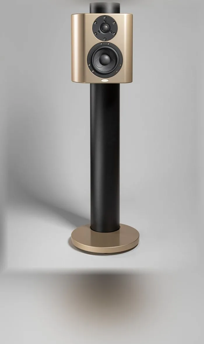 A Minissimo Forte loudspeaker in gold on its black stand