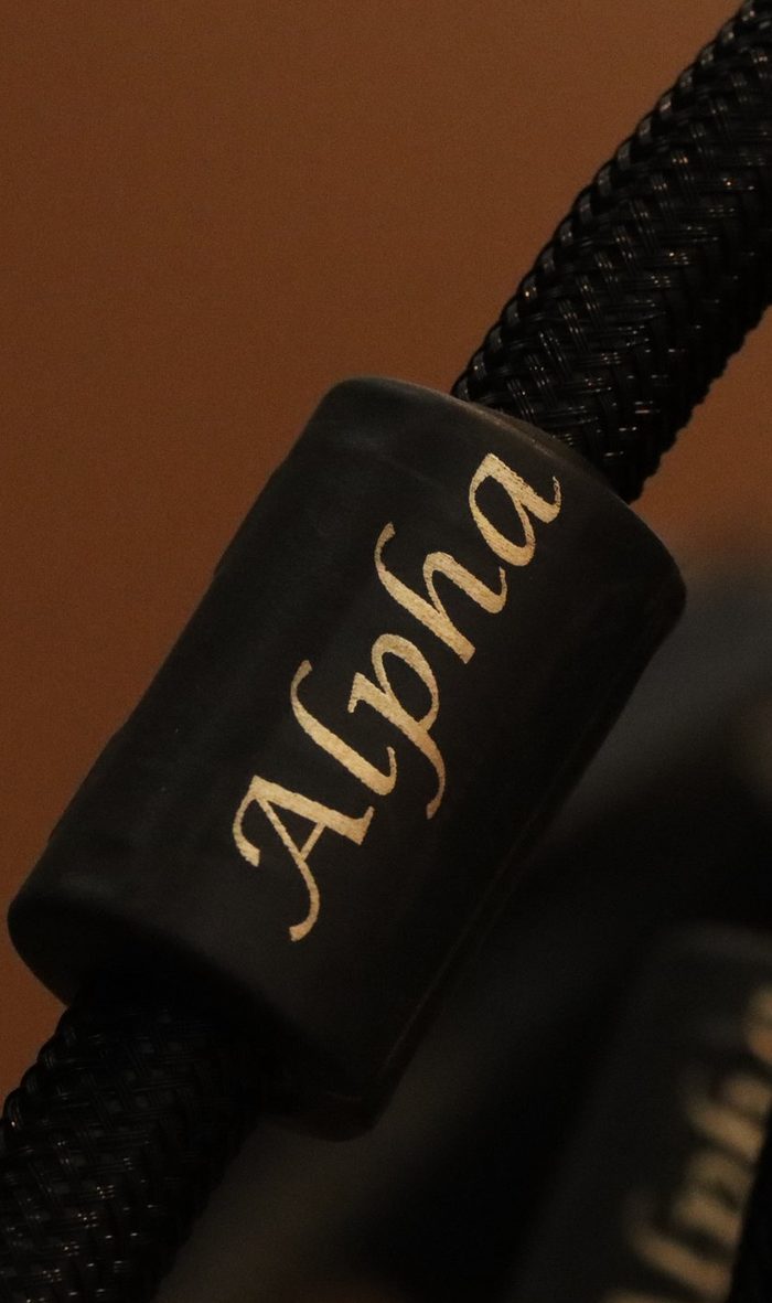 The Alpha badge on a black braided cable