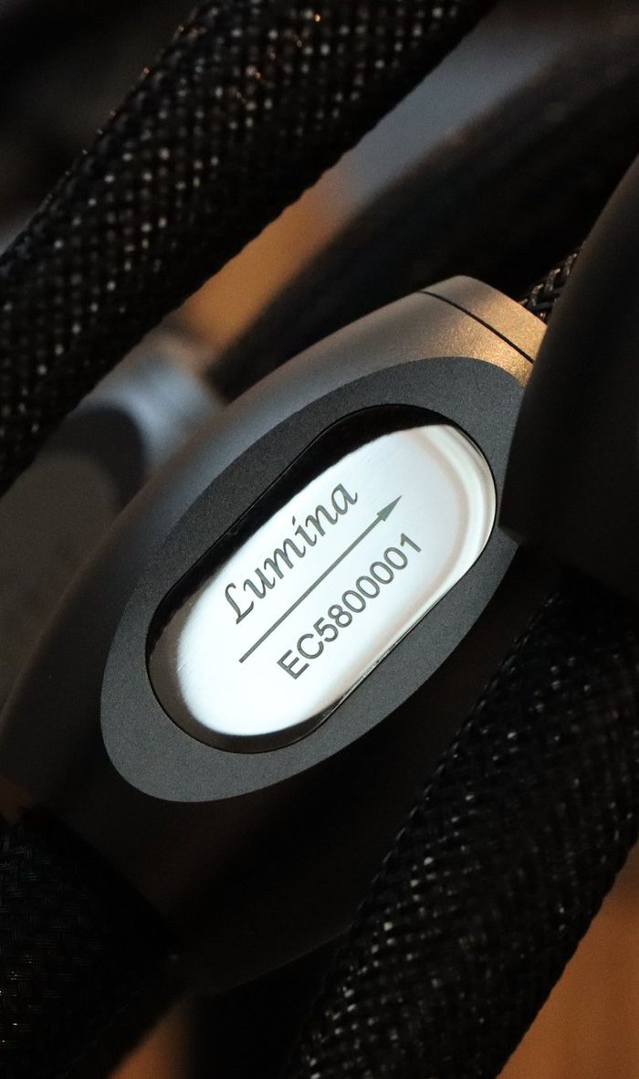 The Lumina badge on a black braided cable