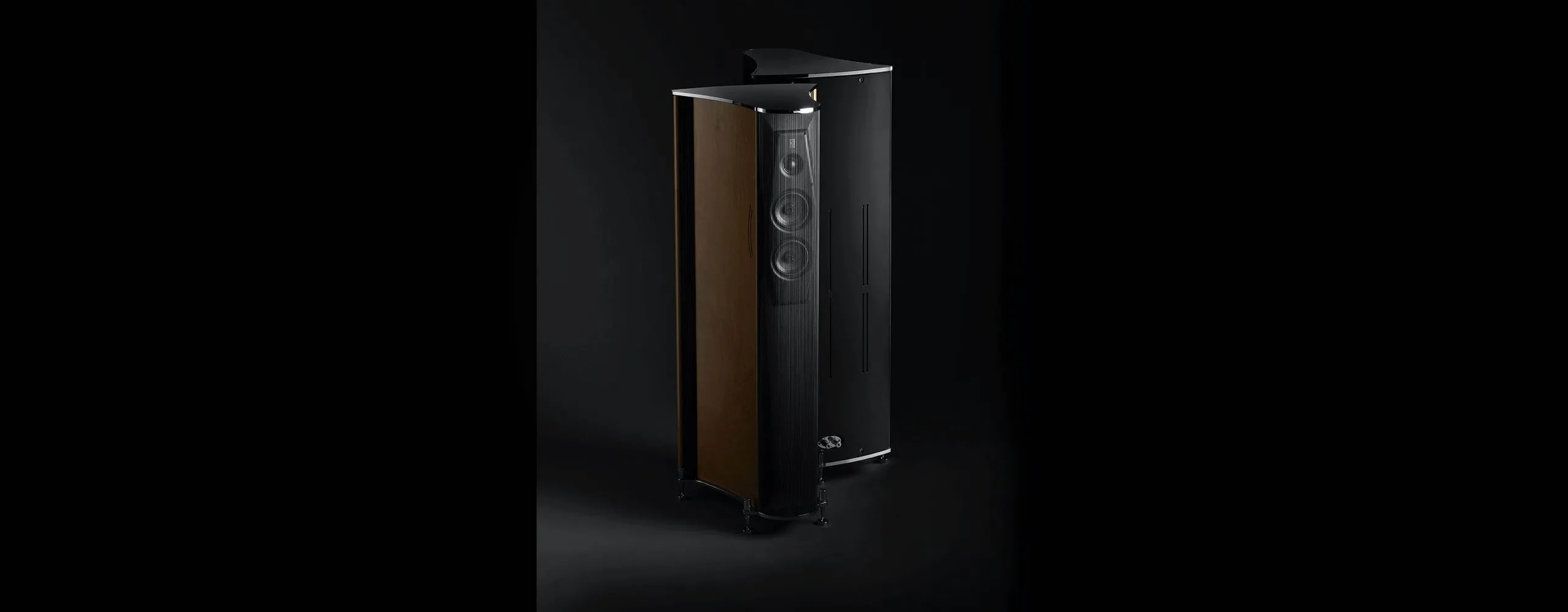 A pair of Ktêma loudspeakers in black lacquer and sycamore, on black