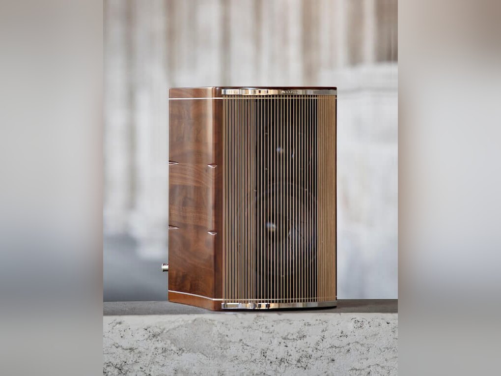 An Accordo Goldberg loudspeaker in walnut, its front a curtain of strings, on a stone sill
