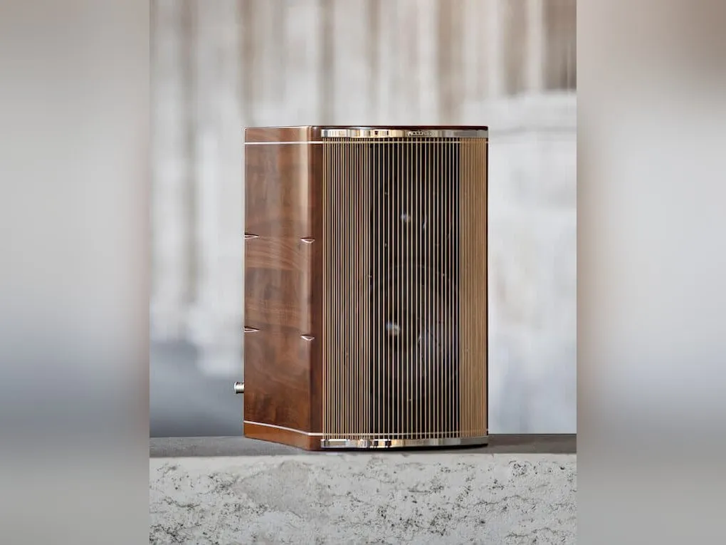 An Accordo Goldberg loudspeaker in walnut, its front a curtain of strings, on a stone sill