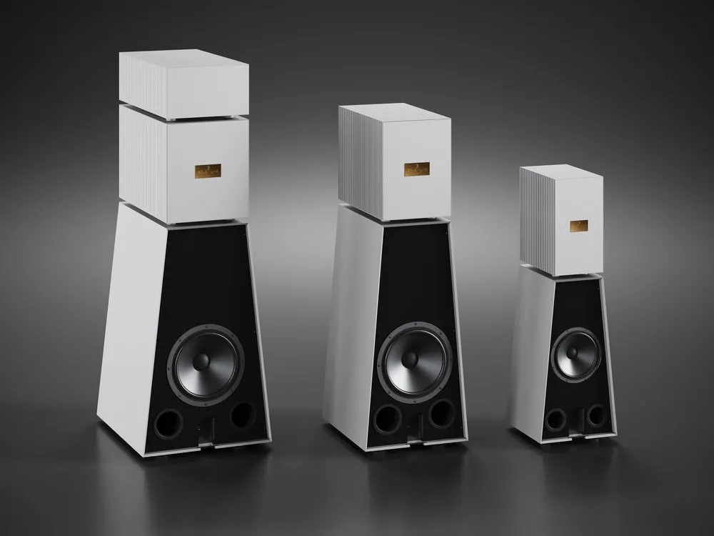 Three Goldmund active loudspeakers in grey aluminium, from the front on a dark ground, tallest to smallest
