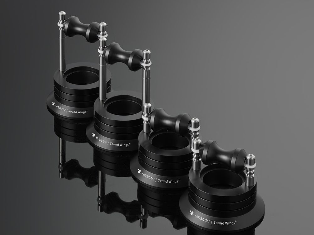 Four Sound Wings+ cable lifters in a row on black, their reflections under them