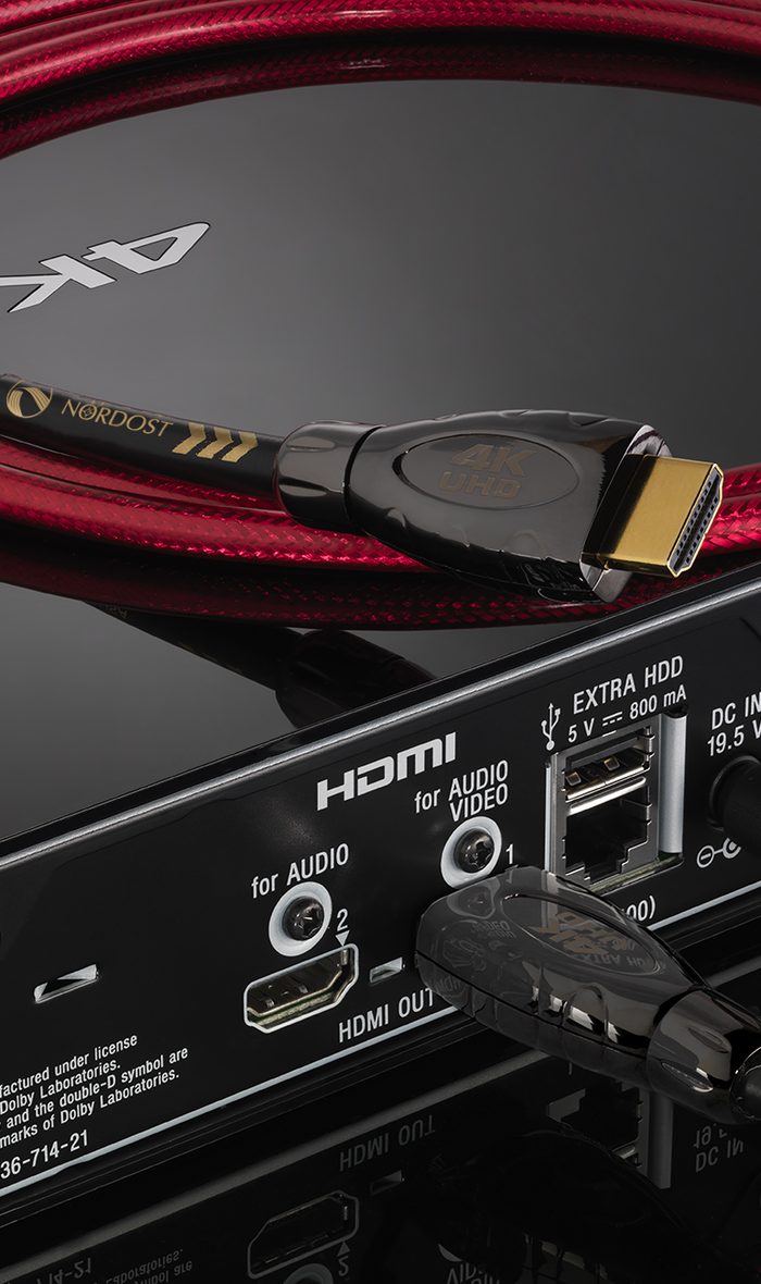 A red Heimdall 2 HDMI cable on a black component