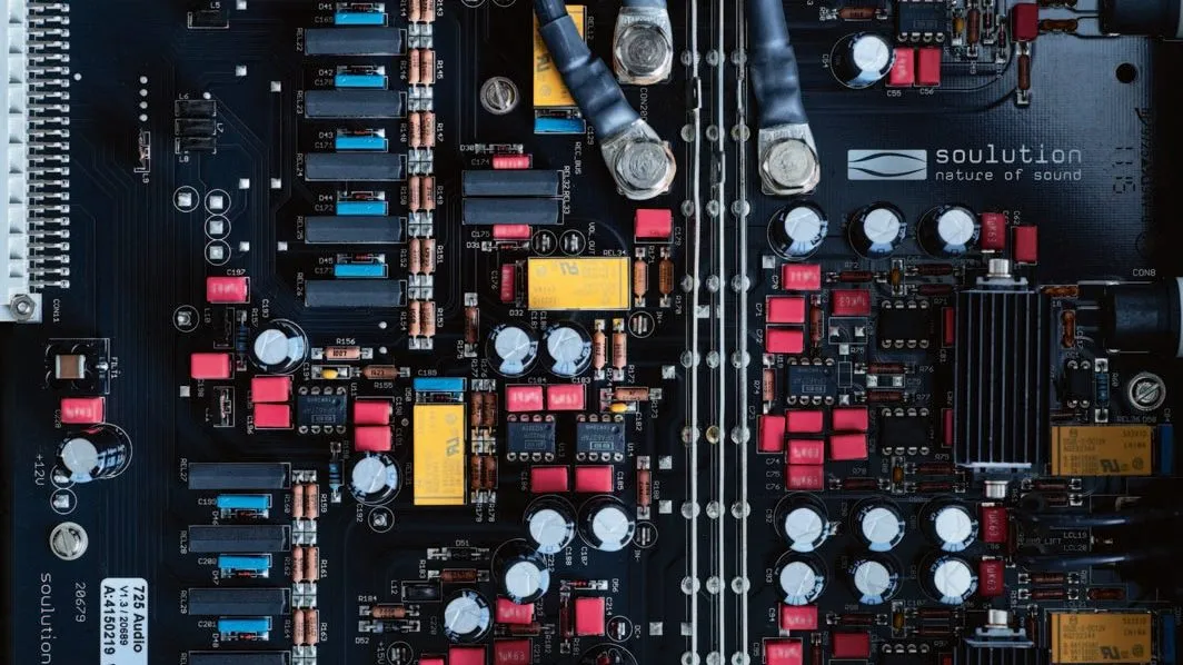 A soulution circuit board from above, black with red and yellow components
