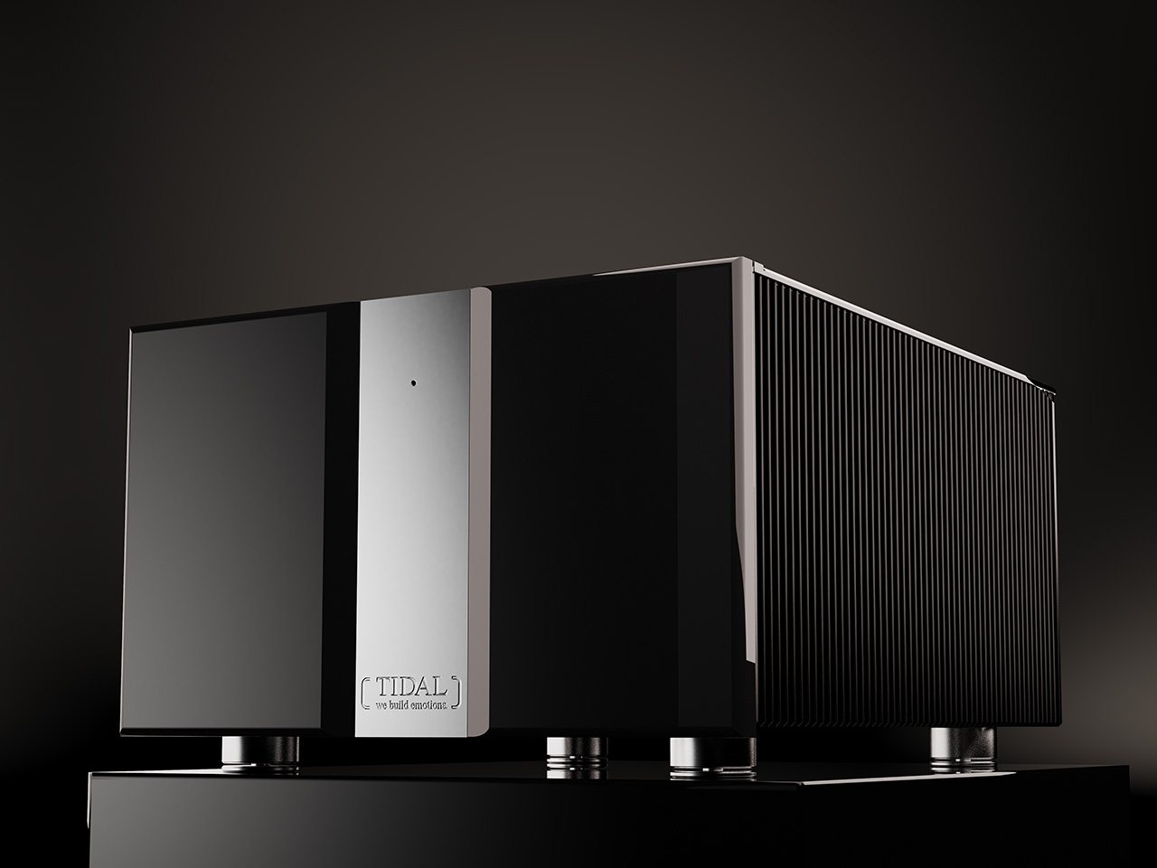 A Ferios monoblock power amplifier in black lacquer with a chrome centre, on black