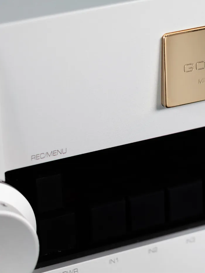 The gold name plate and input keys of a Goldmund Mimesis PH3.8 phono preamplifier, close