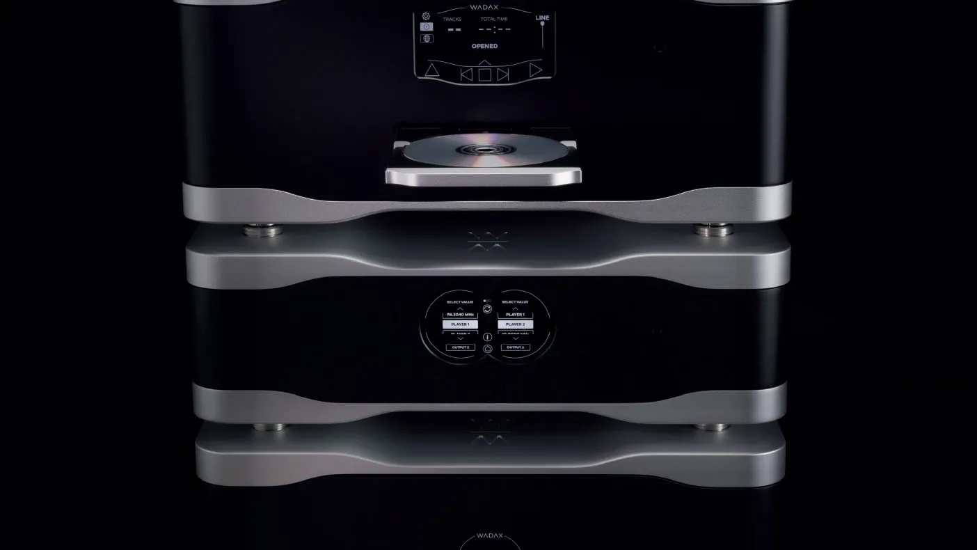A stack of Studio Player components in black and silver, a disc drawer open, on black